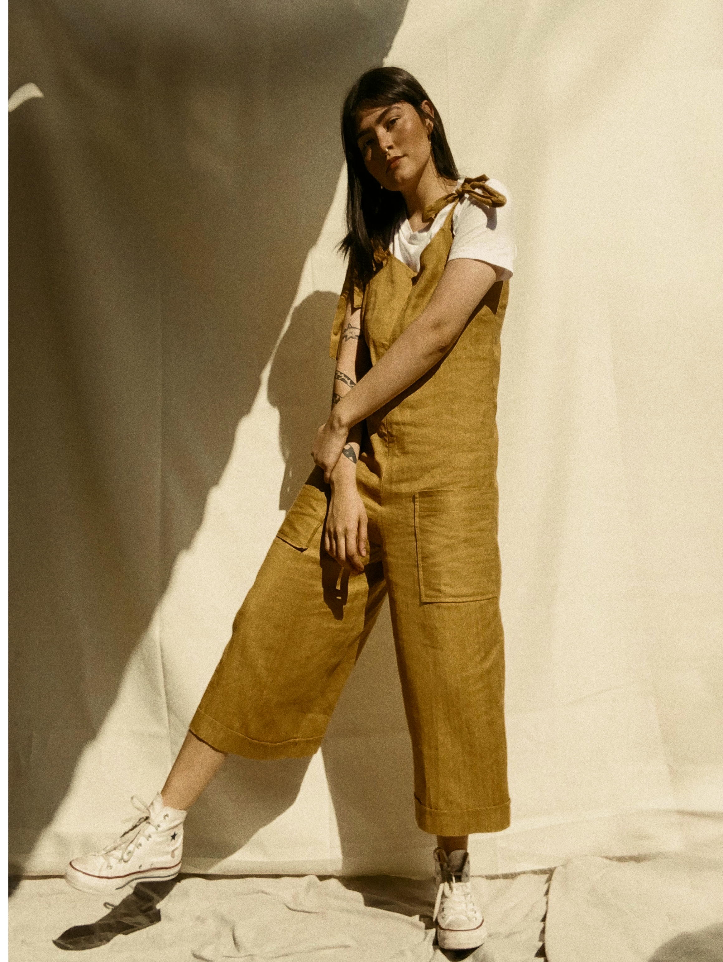 Women standing wearing overalls