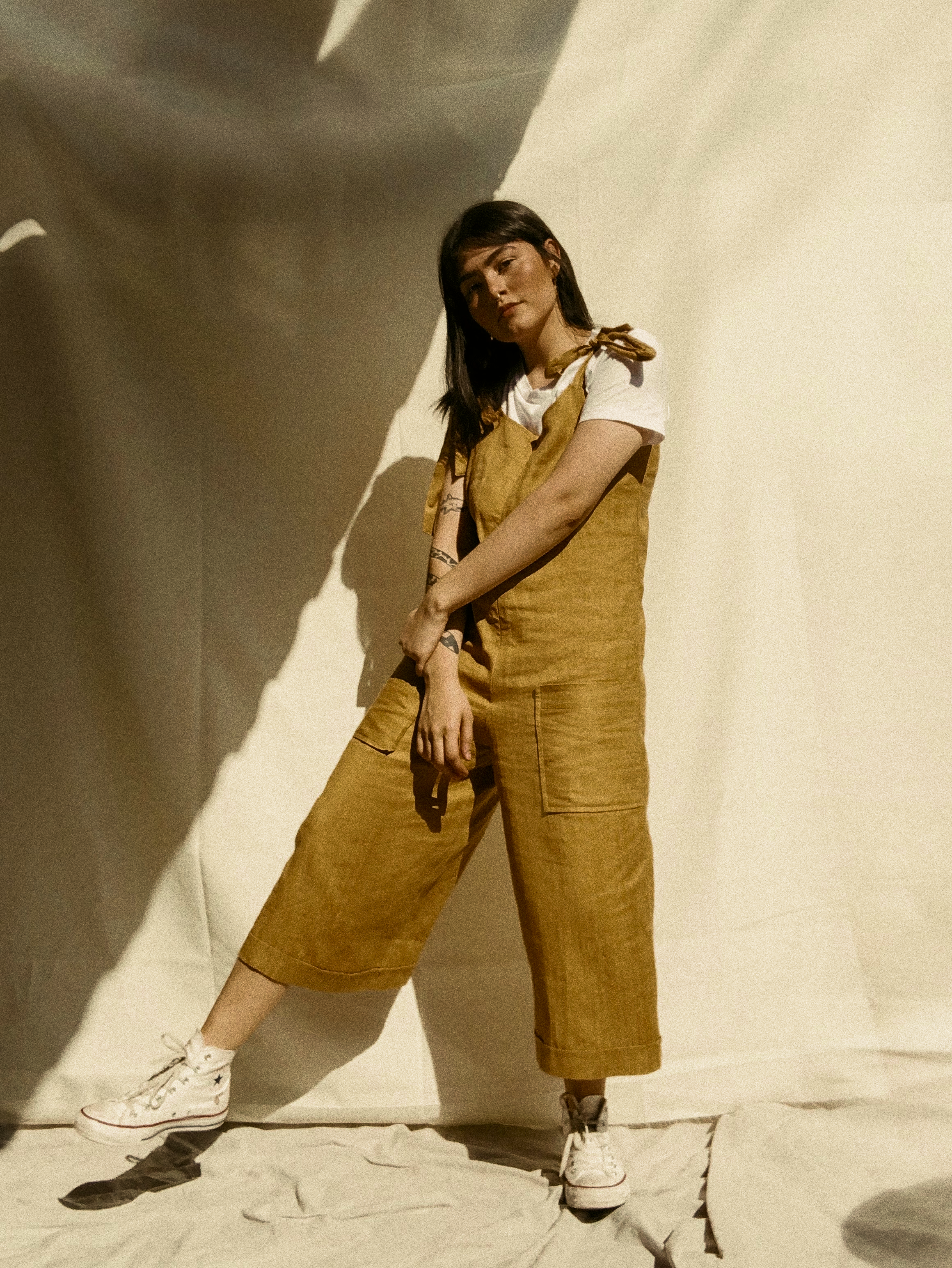 Women standing wearing overalls